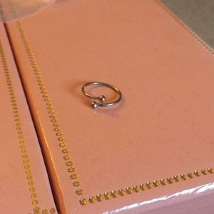 Silver twisty ring with balls on end.